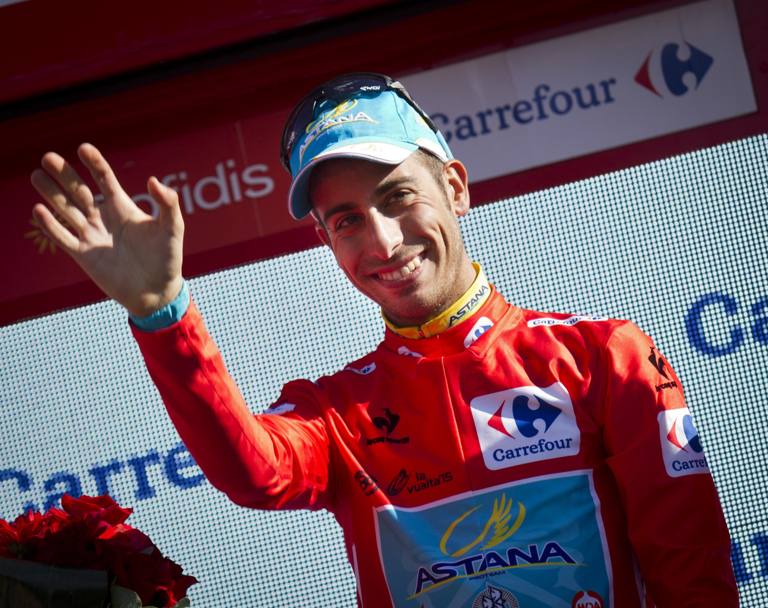 I due volti della Vuelta: il sorriso di Fabio Aru in maglia rossa sul podio, dopo l&#39;impresa che ha rovesciato la corsa. Afp